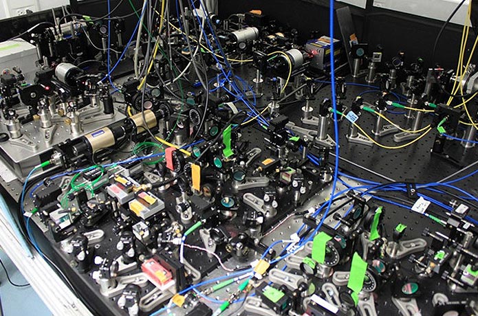 <p>Some of the lasers and optics used in the ACME experiment. (Photo credit: Loic Anderegg)</p>
