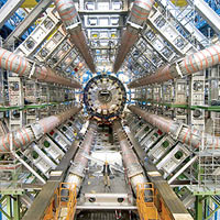 The massive ATLAS detector dwarfs a worker standing in front of it during installation at the Large Hadron Collider. UCSC physicists have been working on the ATLAS project since 1994. Image courtesy of CERN.