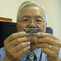 Dr. John Kim with the new ultra-miniature Rubidium atomic clock.
The ultra-miniature Rubidium atomic clock is the next-generation, super-accurate clock no bigger than a matchbox and loses only one second every 10,000 years.
<P>
Image Courtesy: Office of Naval Research. 
